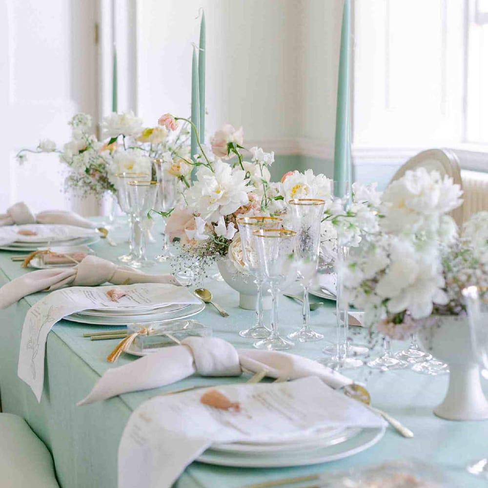 pale green wedding reception decor including a tablecloth and taper candles at pastel Botley's Mansion wedding 