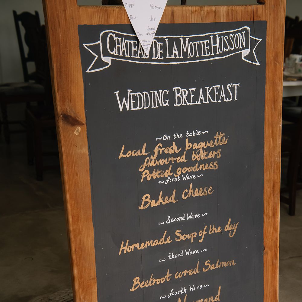 Chateau De La Motte Husson wedding breakfast menu sign on a chalkboard