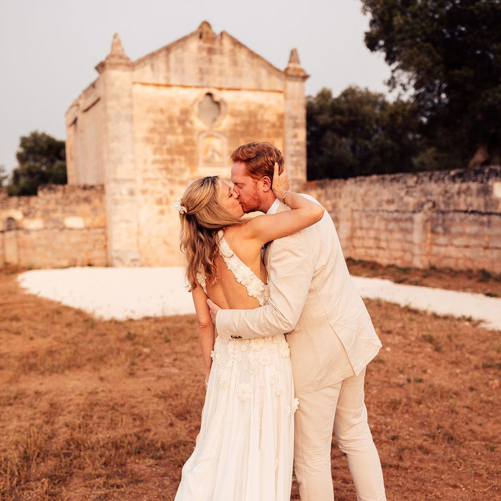 Bride and groom share a kiss on their wedding day in Puglia, Italy