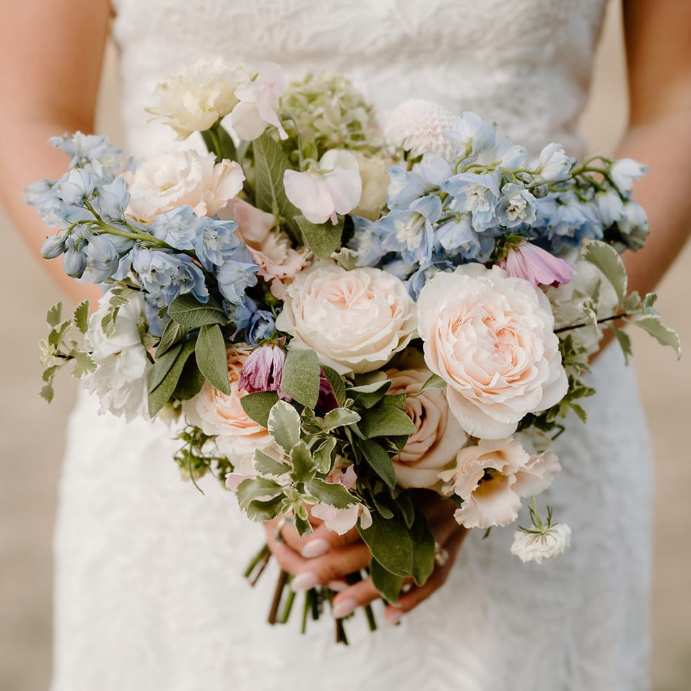 Pastel floral bridal bouquet with roses and green foliage