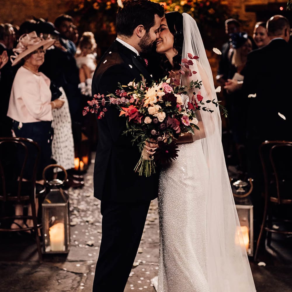 The bride and groom lean in for a kiss together on their wedding day 