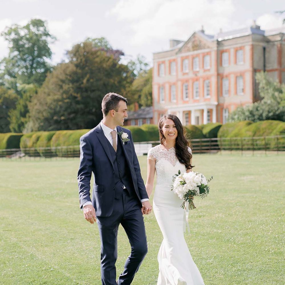 Classic wedding at Ardington House with bride in a fitted wedding dress with lace illusion neckline and groom in a navy suit