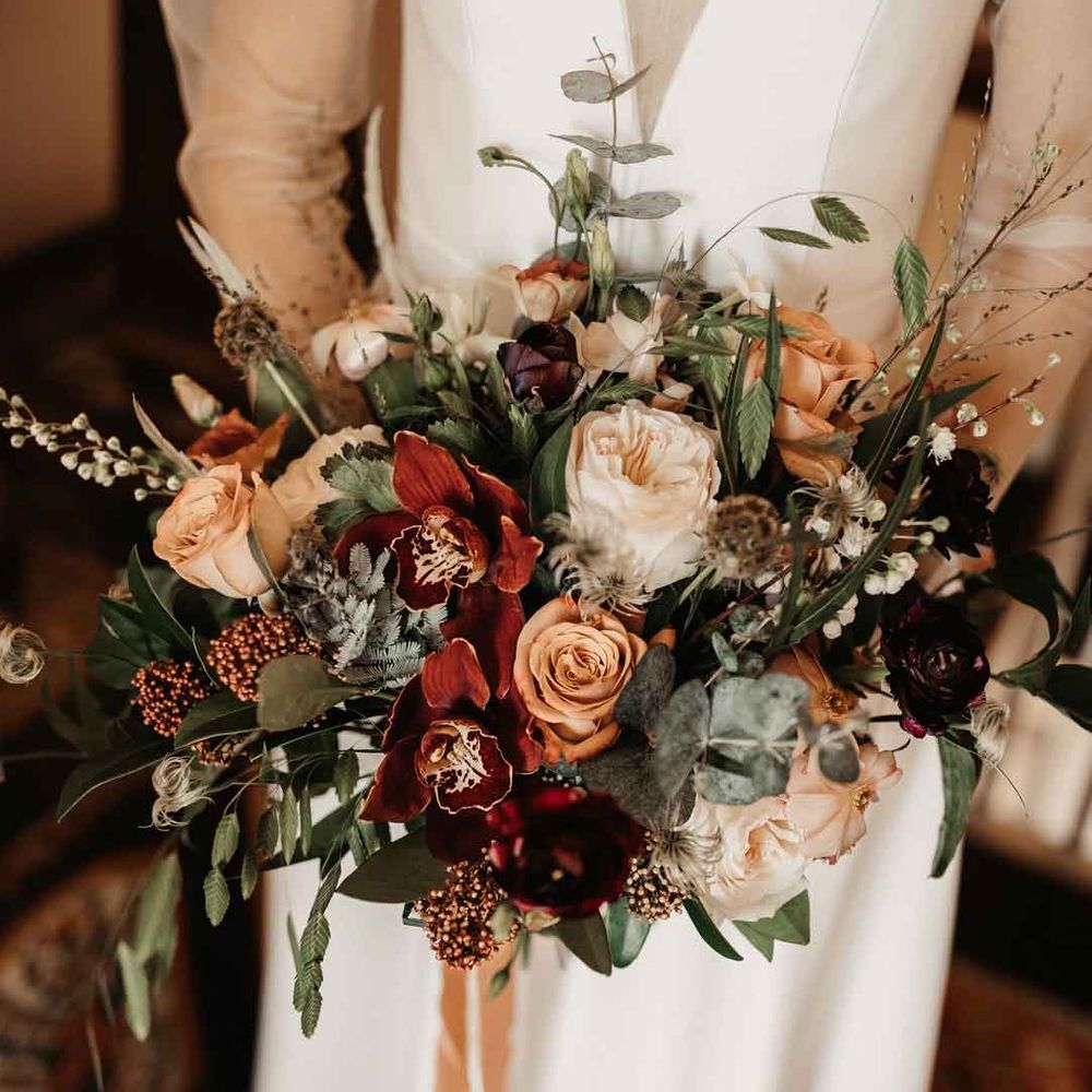 Mixed neutral toned floral and foliage bouquet with garden roses, carnations, peonies, eucalyptus, baby's breath and dried flowers tied with mustard velvet ribbon 