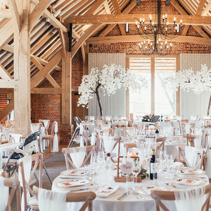 Pink and white neutral theme colour palette with blossom tree decorations with original wood beams 