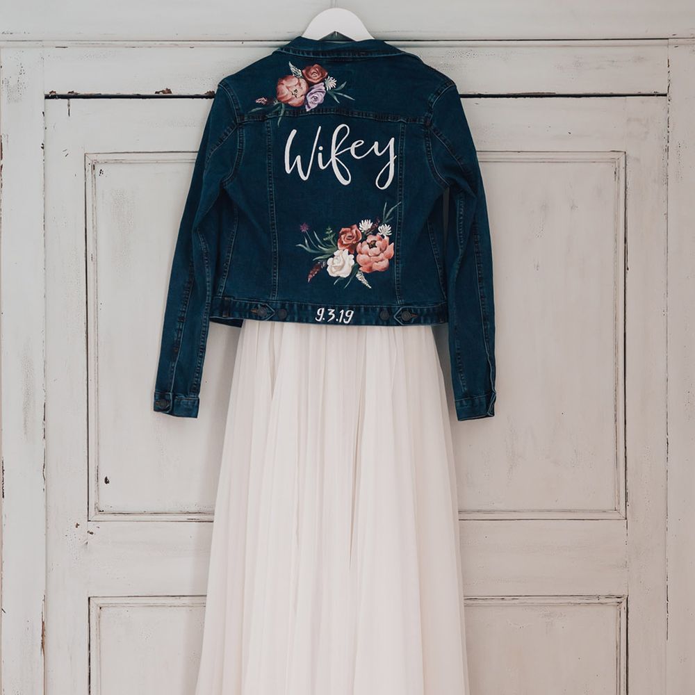 Deep blue bridal denim jacket with handpainted flowers with the bride's new last name 
