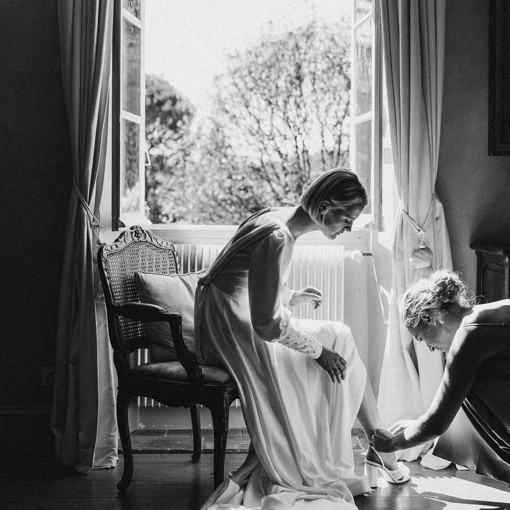 bride on her wedding morning putting on her Loeffler Randall wedding shoes 
