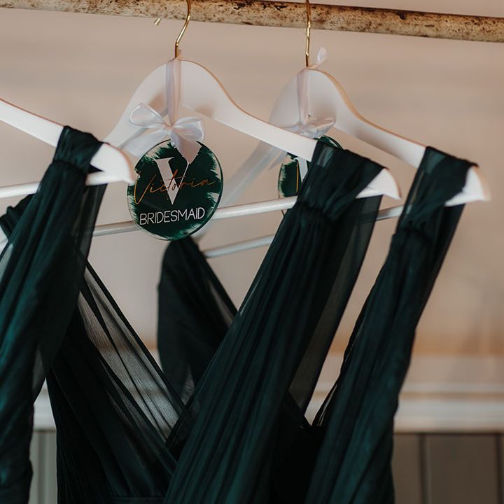 Personalised dark green hangers for the bridesmaid's dresses 