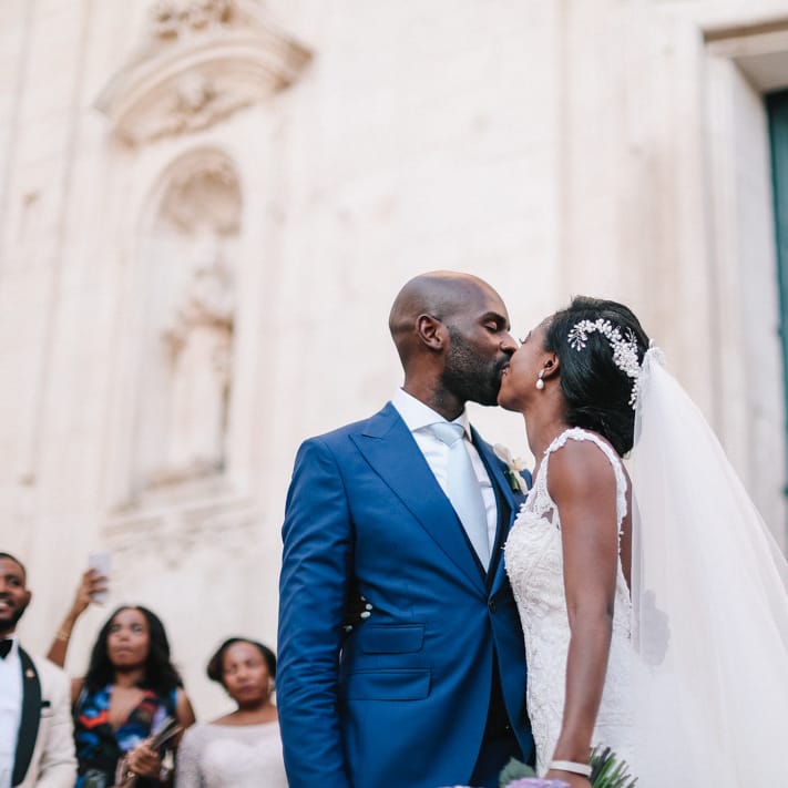 Bride and groom kissing at their wedding in Puglia Italy