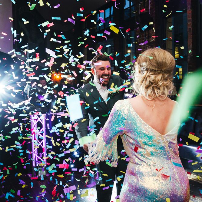 Bride & groom dance whilst confetti cannon explodes around them