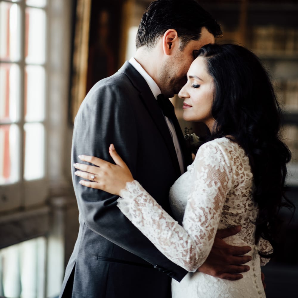 Bride & groom embrace lovingly 