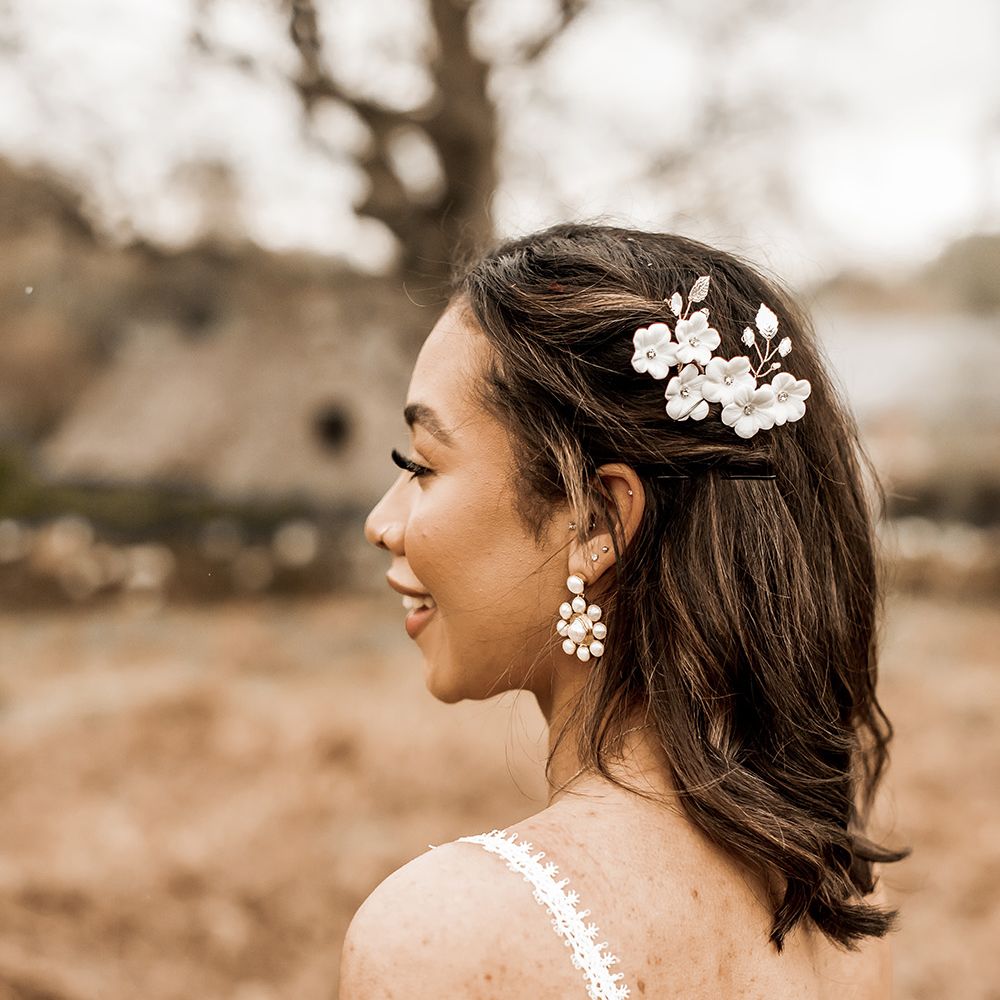 Bride with short bobbed hair with floral hair slide and earrings 