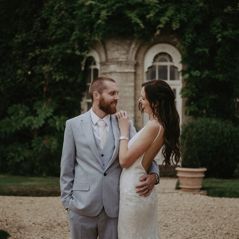 Groom in blue wedding suit with bride in Made With Love wedding dress