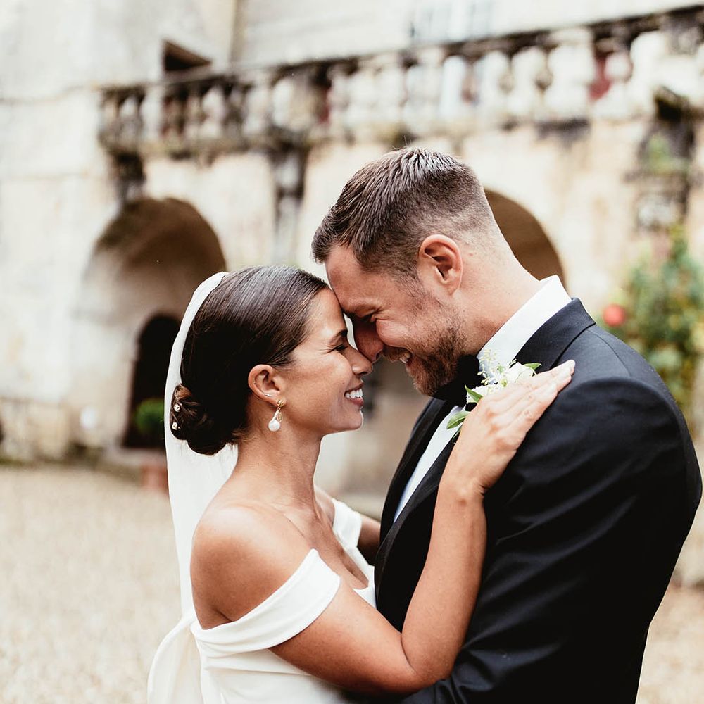 Bride & groom look lovingly at one another on their wedding day after ceremony