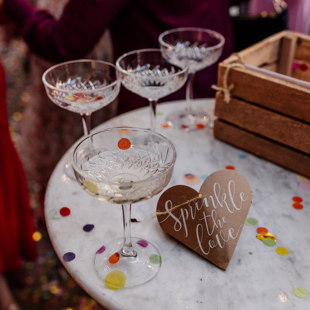crystal cut couple glasses and a confetti box with sprinkle the love heart sign 