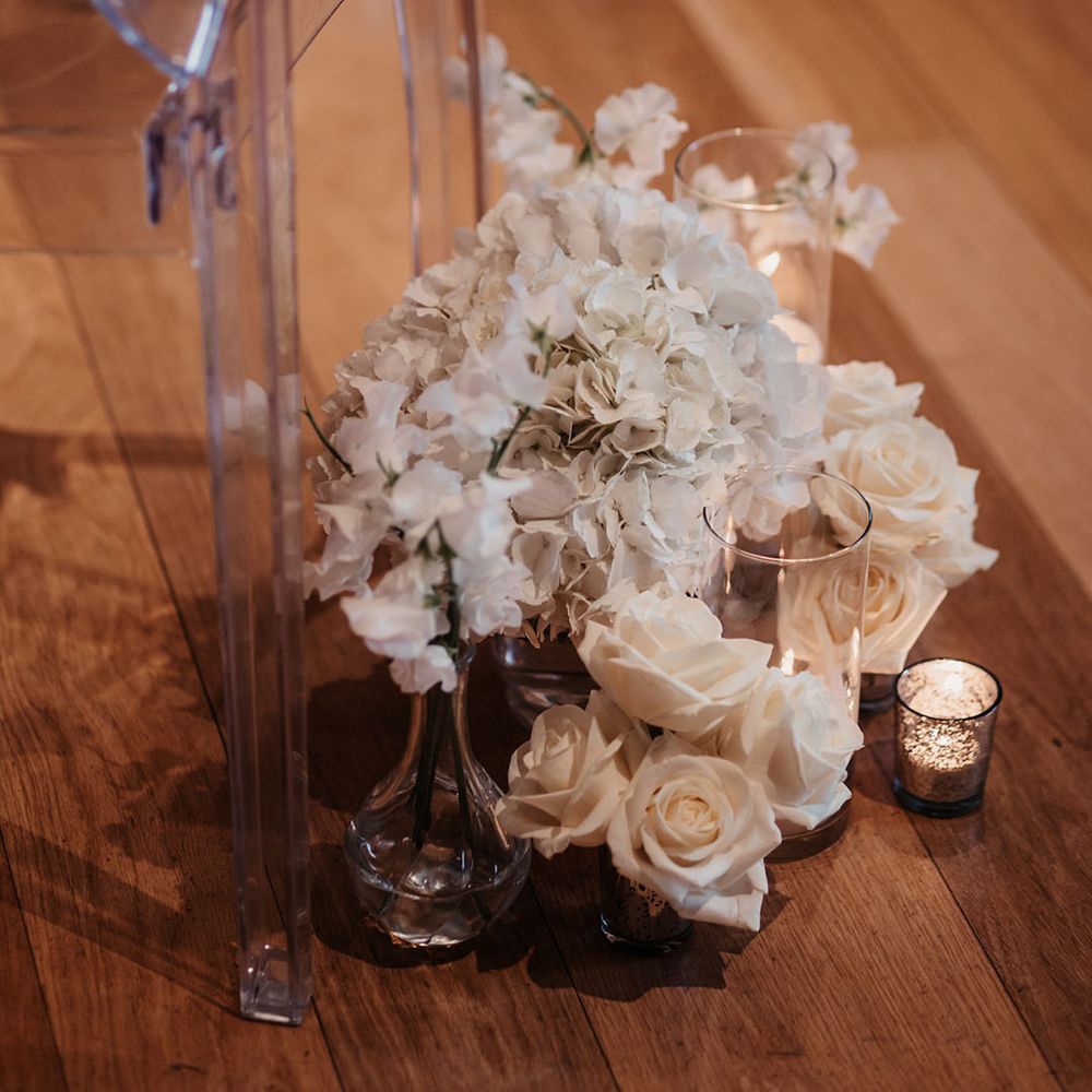 White wedding flower decor with candles for aisle decor 