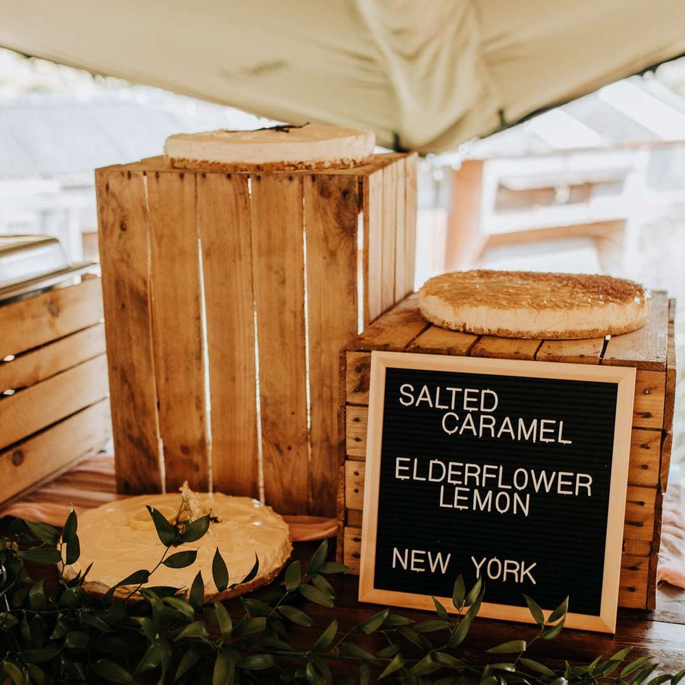 DIY chalkboard sign for different wedding cakes at garden wedding reception