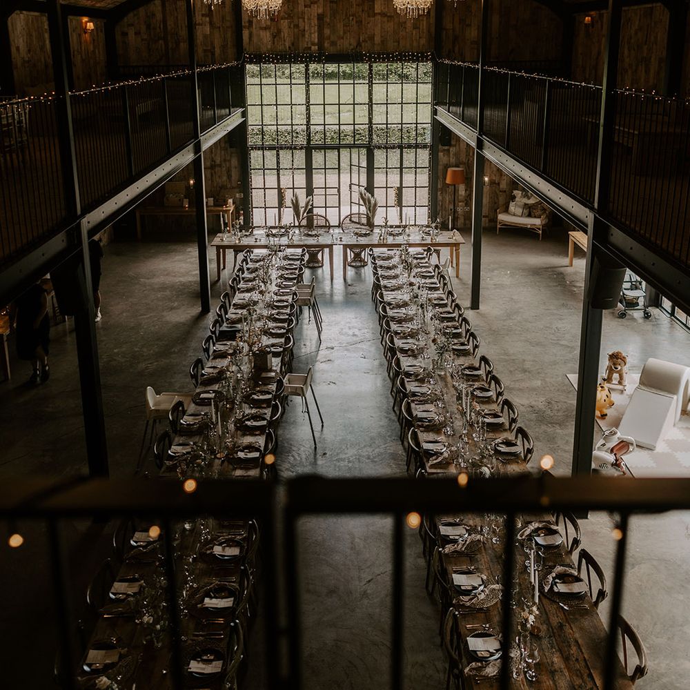 Hidden River Cabins wedding venue in Cumbria wedding tablescape with hanging chandeliers and fairy lights 