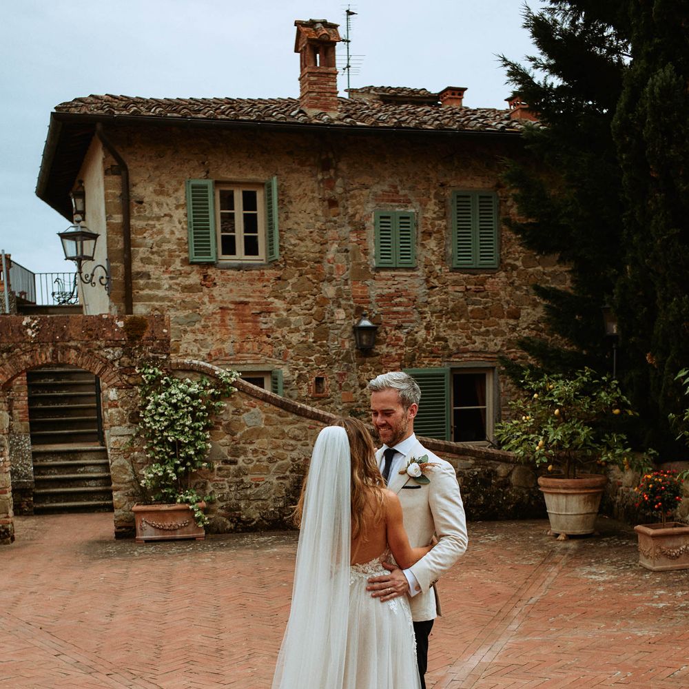 Bride in tulle wedding dress and veil with groom at Italian villa wedding