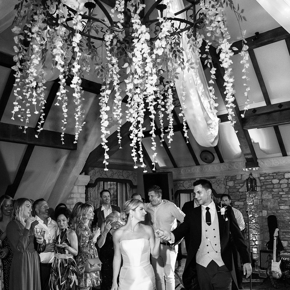 The bride and groom walk onto the dance floor together for their first dance 