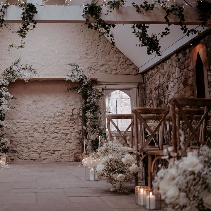 Wyresdale Park wedding with natural styling including gypsophila flower decorations, and flower columns with taper and pillar white candles 