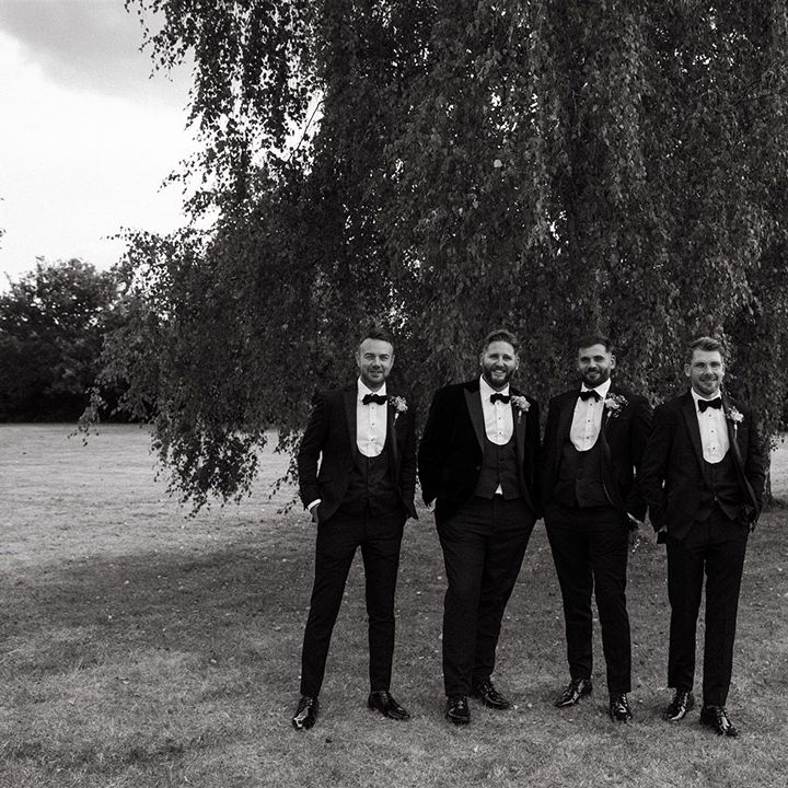 Group photo of the groomsmen in black tuxedos for the wedding day 