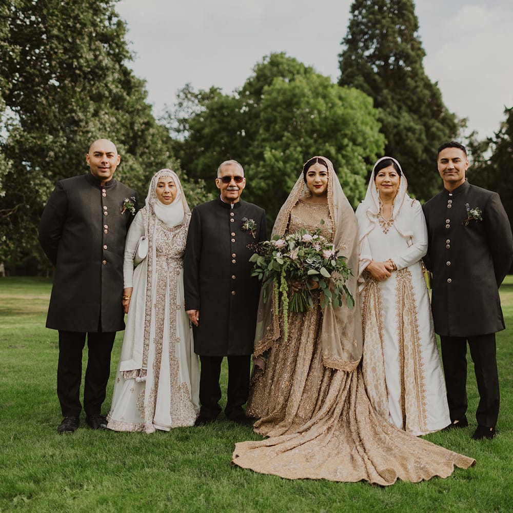 Portrait of the muslim bride in a gold wedding dress with her family 