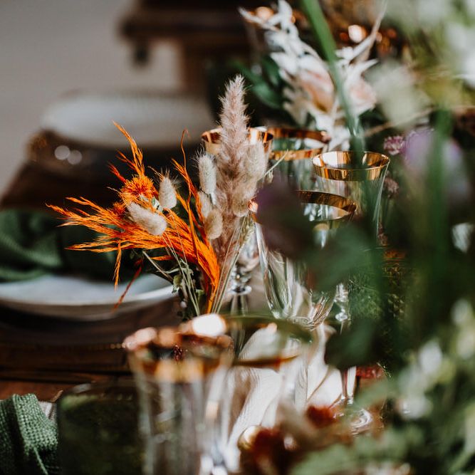 Emerald green and orange wedding table décor for boho wedding