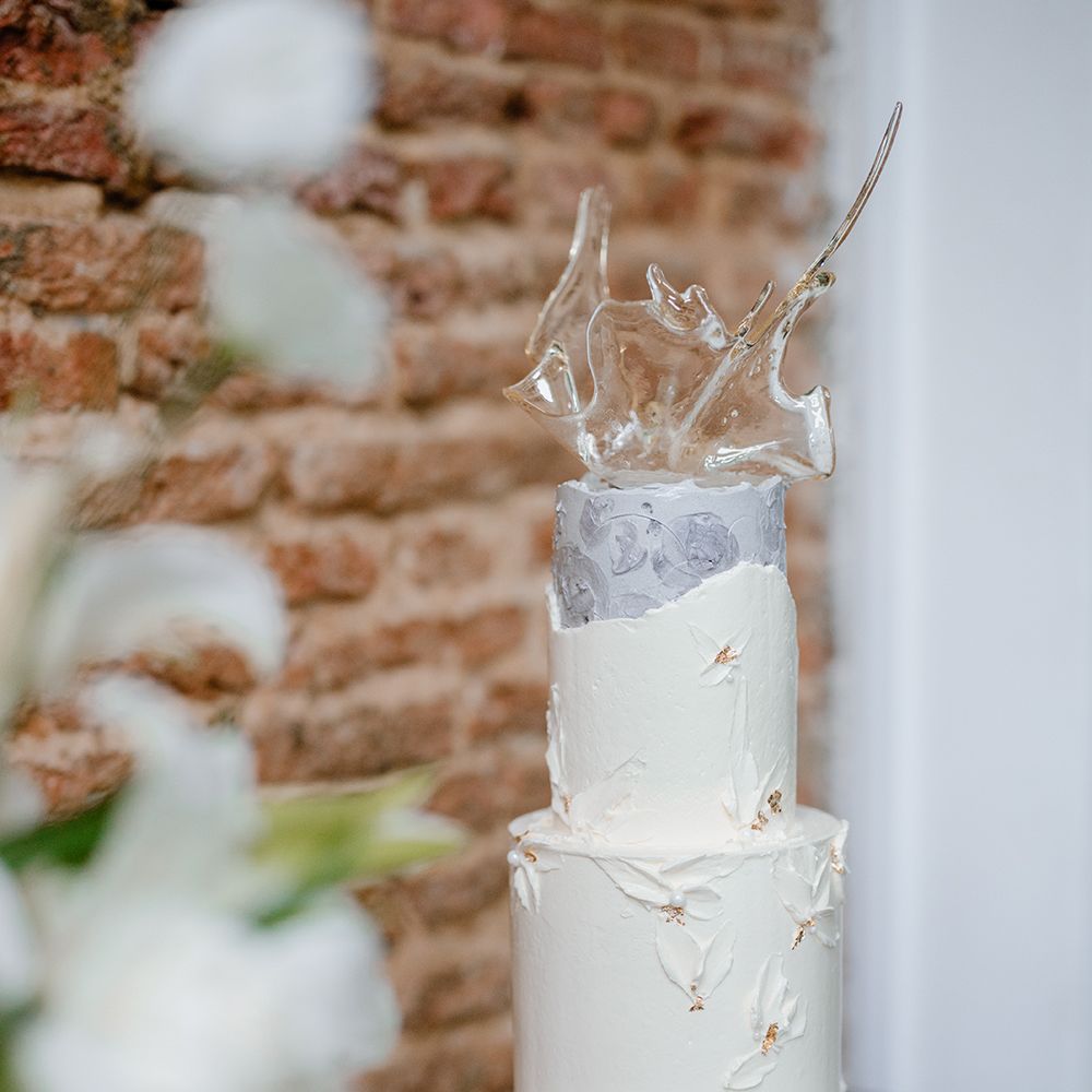 Buttercream wedding cake with sugar sculpture cake topper 
