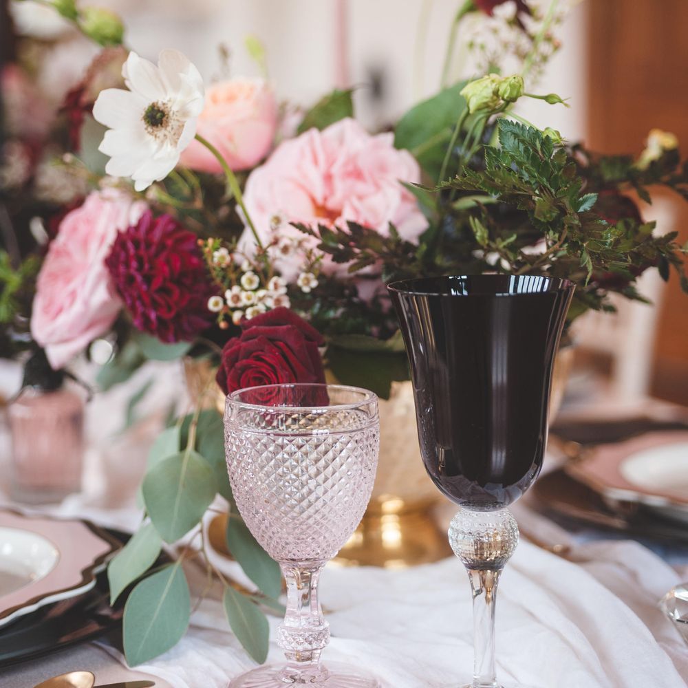 Ornate pink and black glass goblets for dramatic Pomegranate Noir wedding inspiration 