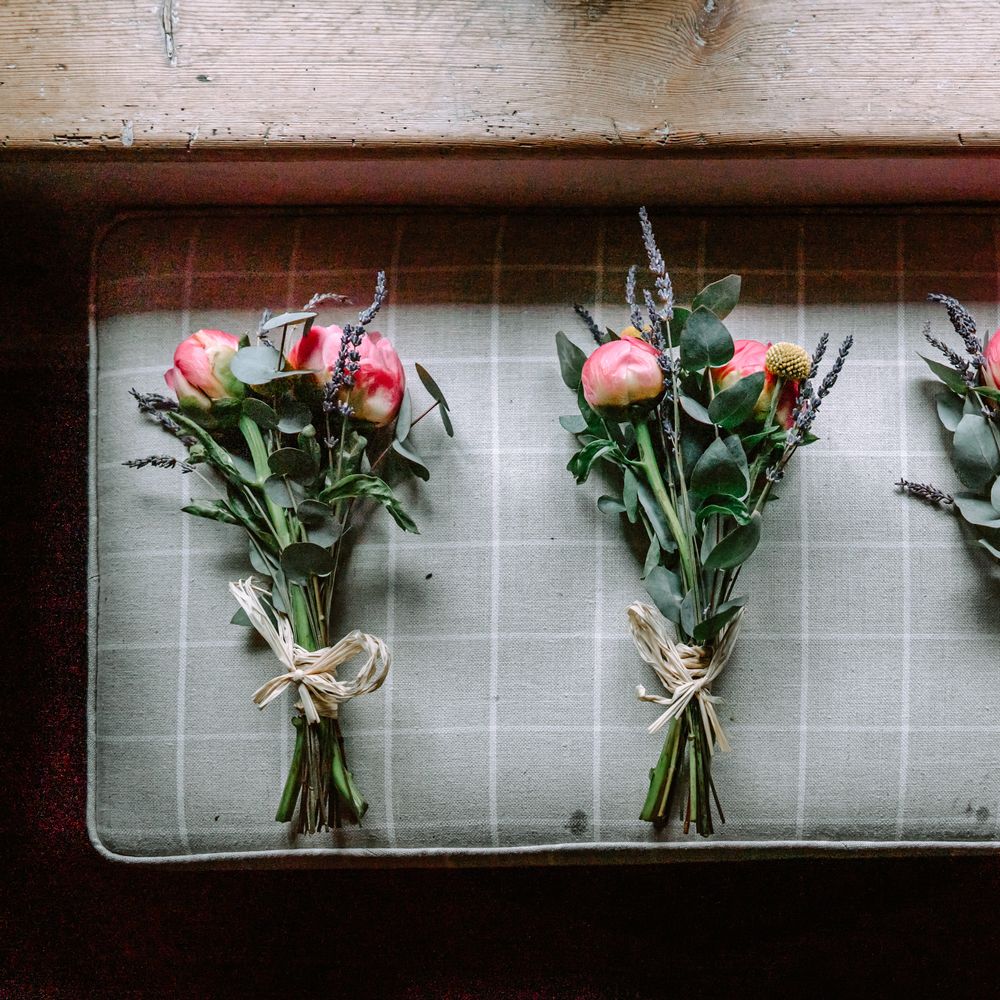 Floral bouquets with tulips and green foliage tied with string