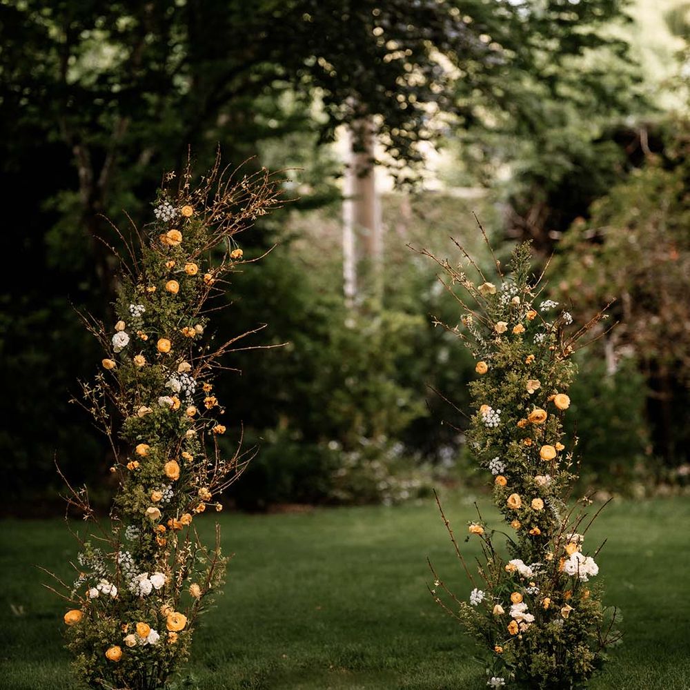 Vertical yellow flower and green floral arrangement 