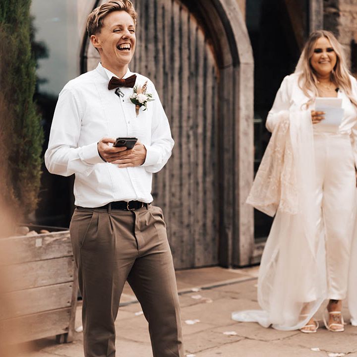 Brides watch as friend gives speech on their wedding day
