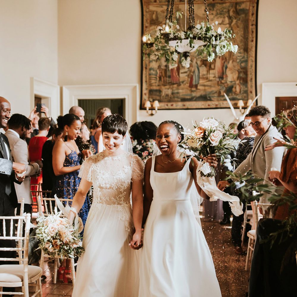 LGBTQI+ wedding at Elmore Court with Black African bride in a Essense of Australia wedding dress and bride with short hair in a Ana Kara bridal gown 