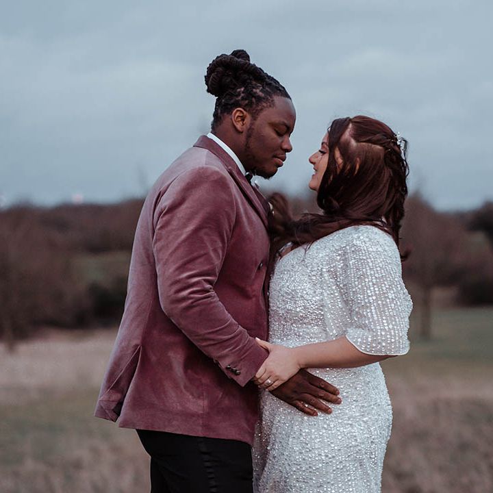 Groom wraps his arms around bride on their wedding day