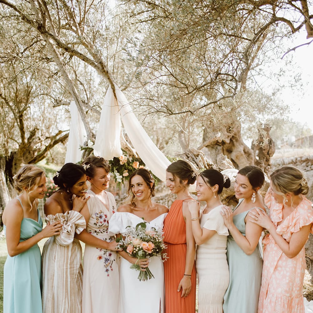 Smiling bride surrounded by her bridesmaids 