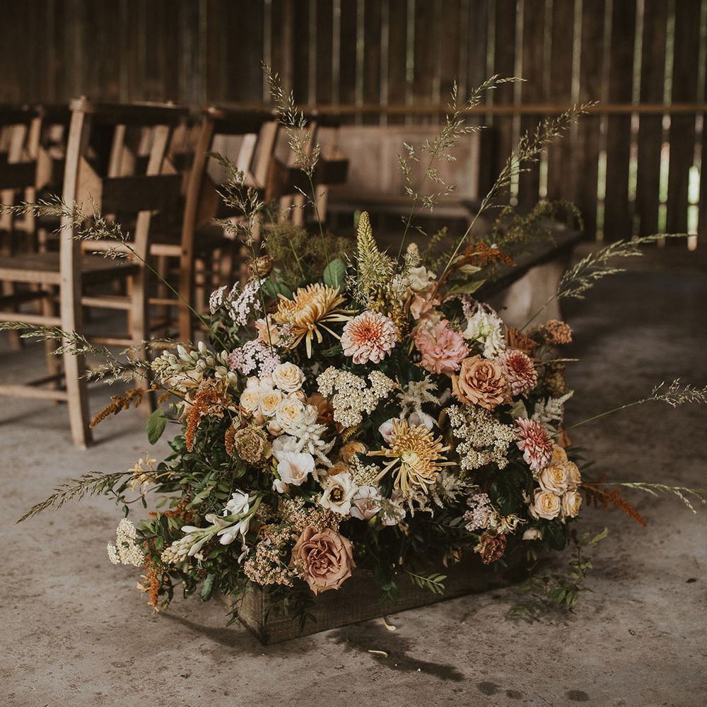 Dusty rose, ivory and rust coloured wedding flower aisle decoration for rustic wedding 