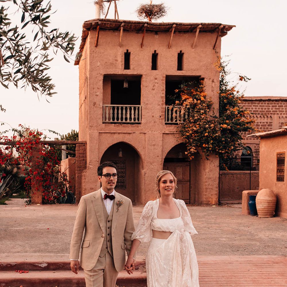 Bride in Grace Loves Lace bridal separates walking hand in hand with the groom around Beldi Country Club wedding venue 