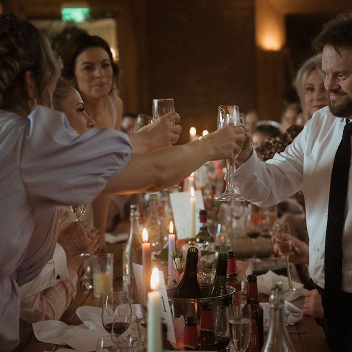 Wedding guests make a toast together at the wedding breakfast 