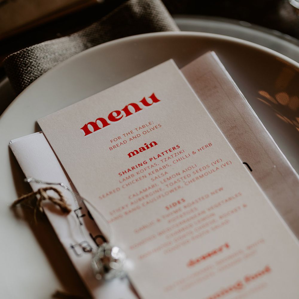 Greek style wedding menu on orange and white theme stationery 