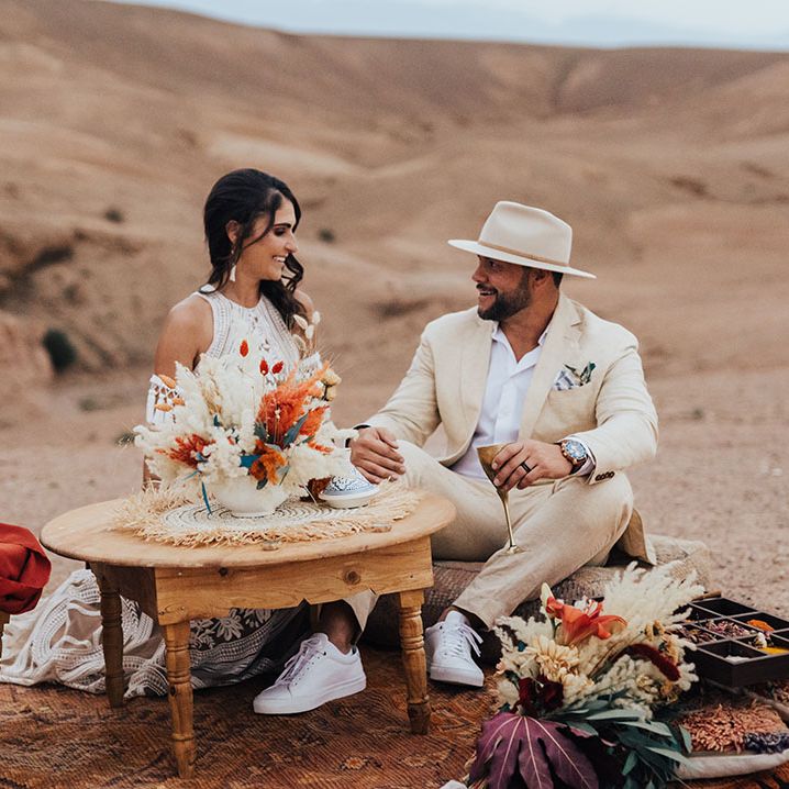 Intimate wedding breakfast between the bride and groom as they sit on the floor 