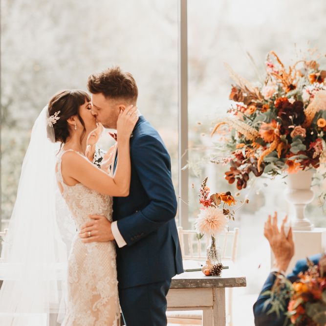 Bride and groom kissing at Millbridge Court wedding ceremony 