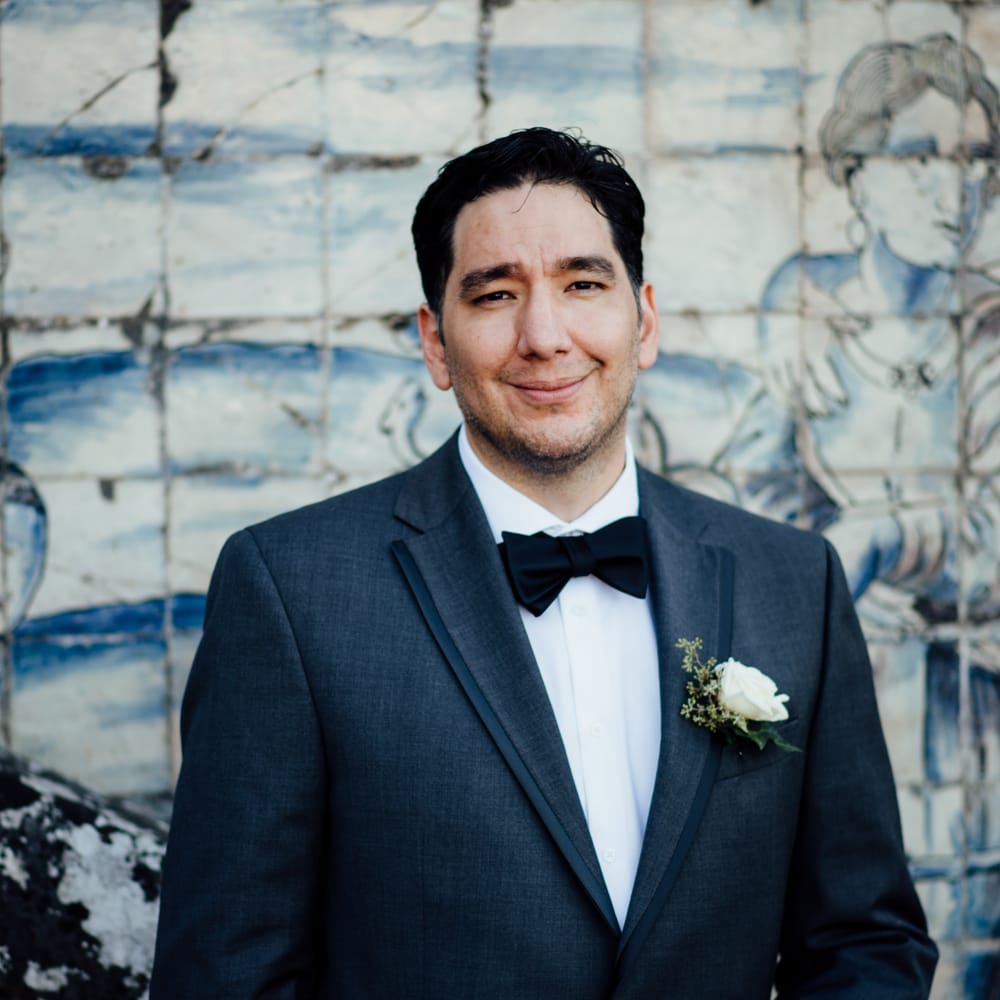 Groom wears black tie 