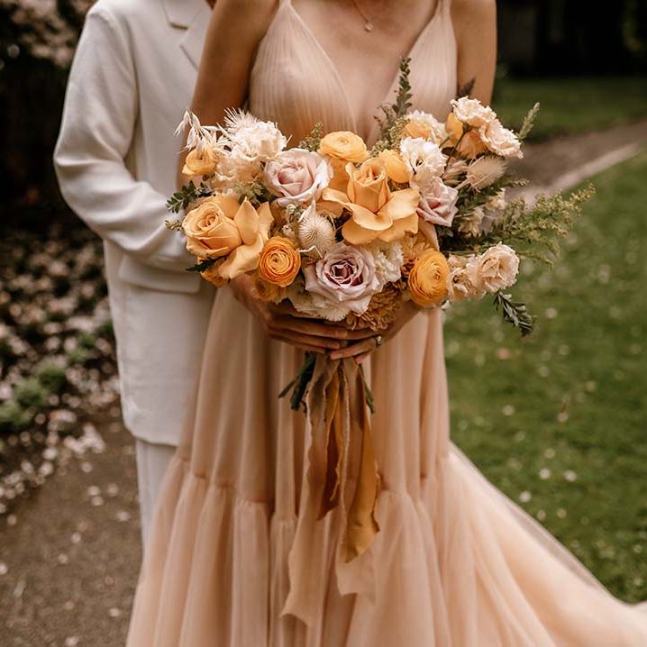 Honey yellow and blush pink wedding bouquet with peeled back roses 