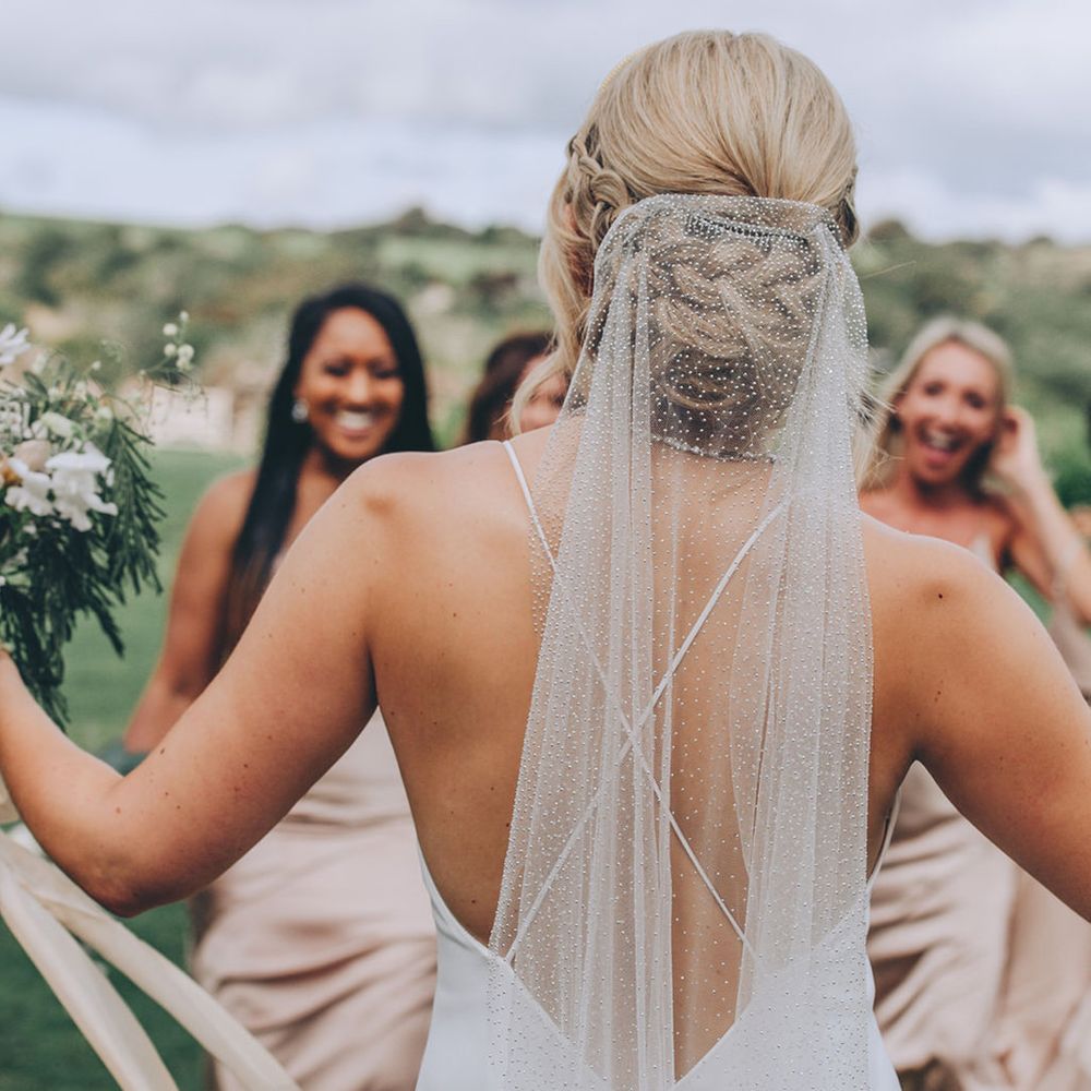 Braided updo for bride with veil
