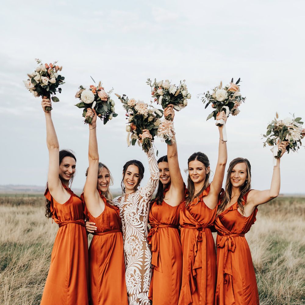 Bridal party in silk long one ruffle bridal dresses open champagne with Bride in Lacy detail wedding dress 