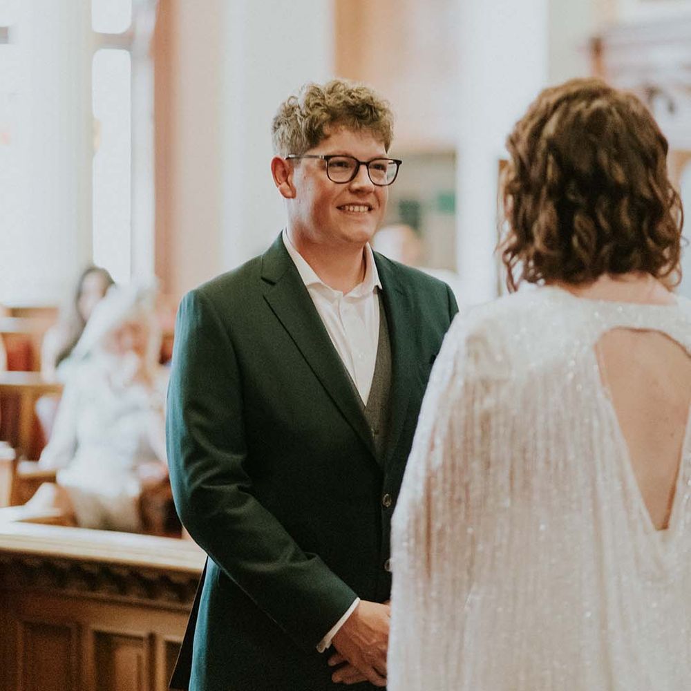 Groom wears green jacket for wedding ceremony