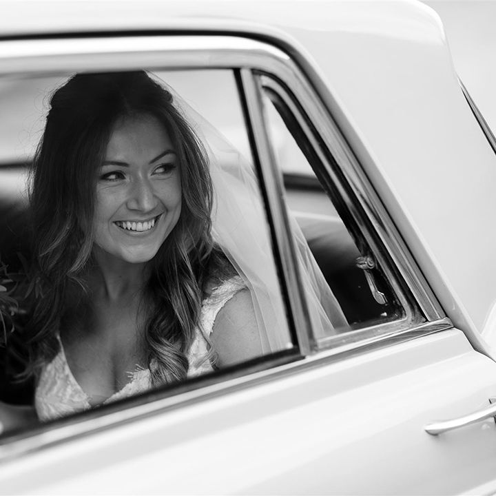Bride in vintage wedding car