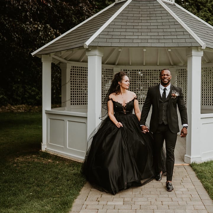 Bride & groom walk with one another on their wedding day
