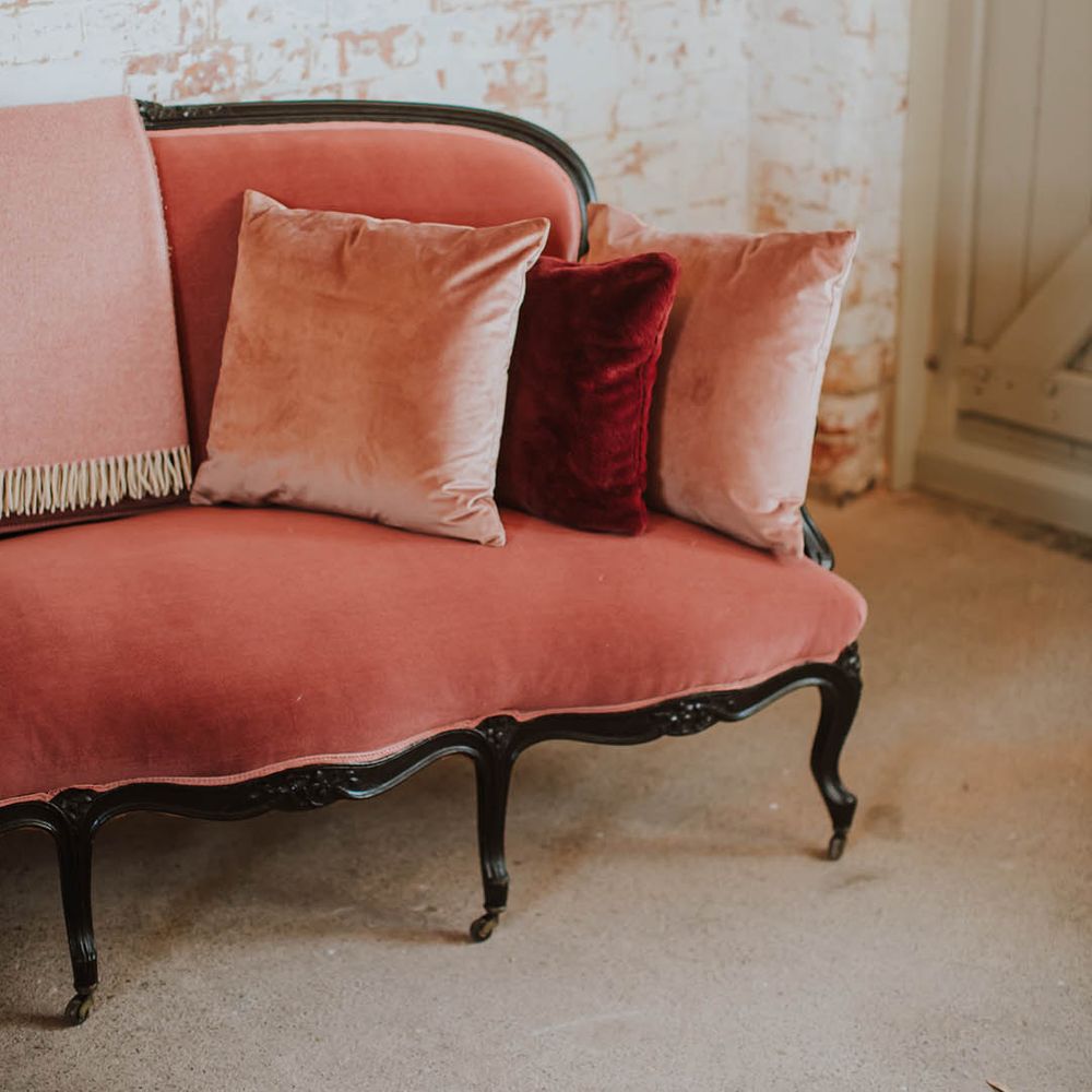 vintage pink suede ornate sofa and scatter cushions at Prestwold Hall Barns 