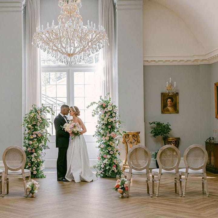 Rushton Hall wedding venue with chandeliers, flower columns and pastel details 